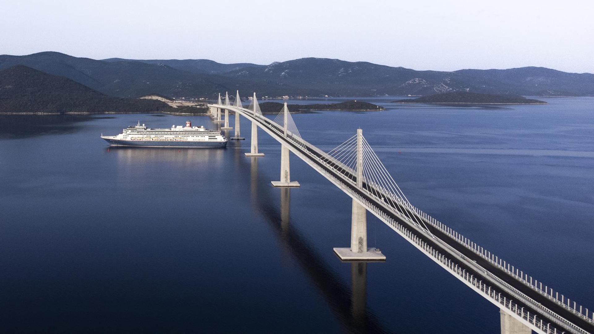 23.06.2022., Komarna - Fotografija iz zraka prolaska prvog velikog kruzera ispod Peljeskog mosta. Photo: Milan Sabic/PIXSELL