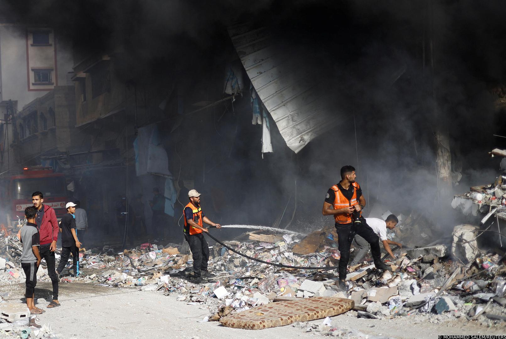 Palestinian firefighters work to put out a fire at the site of Israeli strikes on a residential building, amid the ongoing conflict between Israel and Palestinian Islamist group Hamas, in Khan Younis in the southern Gaza Strip, November 7, 2023. REUTERS/Mohammed Salem Photo: MOHAMMED SALEM/REUTERS