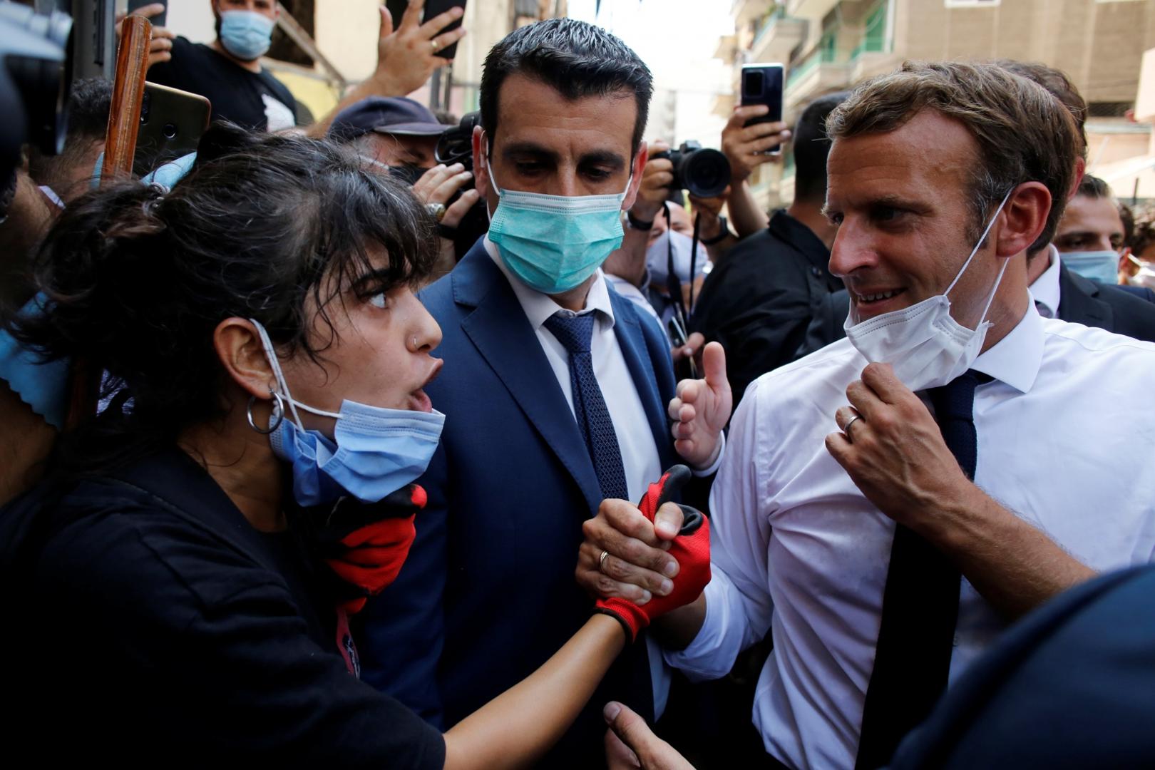 French President Emmanuel Macron visits devastated streets of Beirut French President Emmanuel Macron listens to a resident as he visits a devastated street of Beirut, Lebanon August 6, 2020. Thibault Camus/Pool via REUTERS POOL