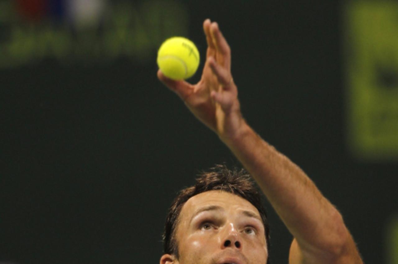 \'Ivo Karlovic of Croatia serves to Nikolay Davydenko of Russia during their match at the Qatar Open tennis tournament in Doha January 6, 2011. REUTERS/Jamal Saidi (QATAR - Tags: SPORT TENNIS)\'