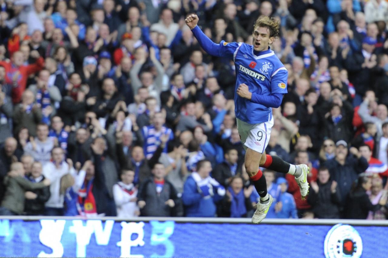 'Rangers\' Nikica Jelavic celebrates his goal against Dundee United during their Scottish Premier League soccer match at Ibrox Stadium, Glasgow, Scotland, November 5, 2011. REUTERS/Russell Cheyne (BRI