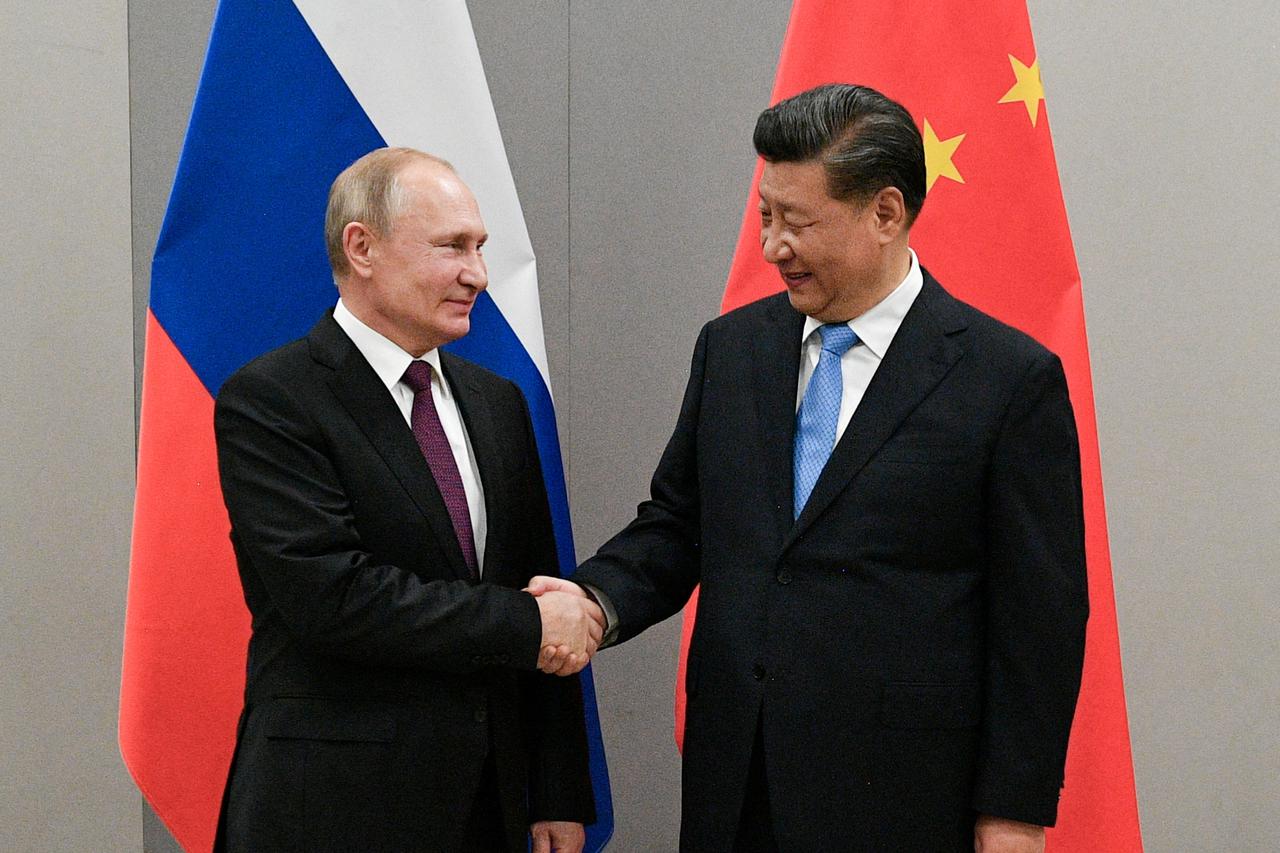 FILE PHOTO: Russian President Putin meets with Chinese President Xi during their meeting on the sideline of the BRICS summit in Brasilia