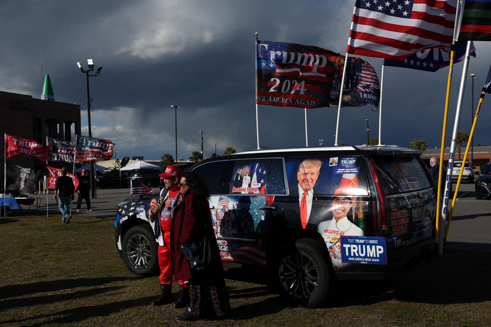 Supporter of former U.S. President and Republican presidential candidate Donald Trump pose in from of a decorated vehicle ahead of his South Carolina Republican presidential primary election night party in Columbia, South Carolina, U.S. February 24, 2024. REUTERS/Shannon Stapleton Photo: SHANNON STAPLETON/REUTERS