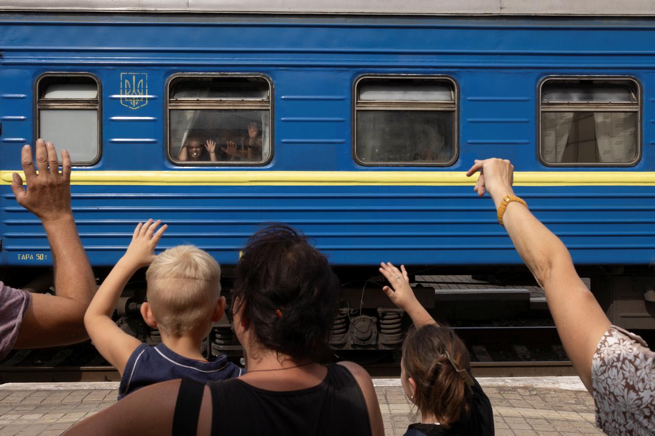 People bid farewell to relatives as they flee on an evacuation train from Russian troop advances in Pokrovsk