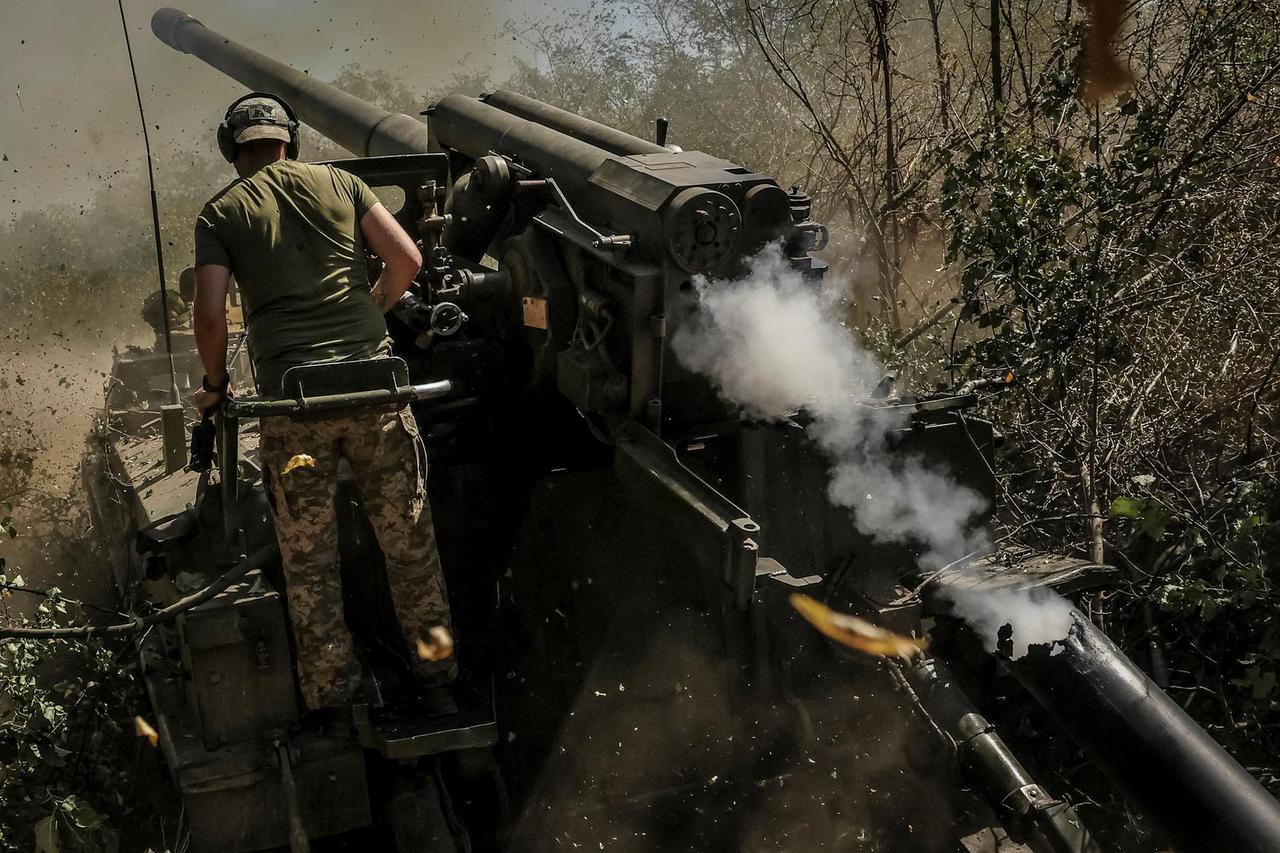 Ukrainian servicemen fire a self-propelled howitzer towards Russian troops at a frontline near the town of Chasiv Yar