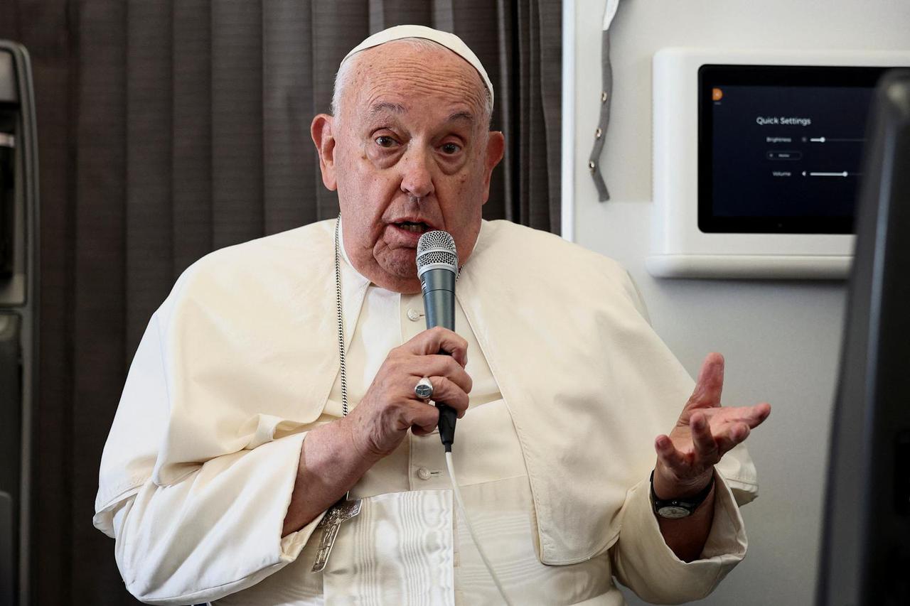 Pope Francis holds a news conference aboard the papal plane