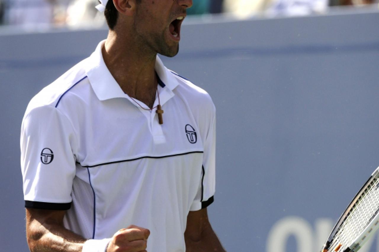 \'Novak Djokovic of Serbia (1) celebrates a point against Roger Federer of Switzerland (3) during their Men\'s Semi Final 2011 US Open match at the USTA Billie Jean King National Tennis Center in New 