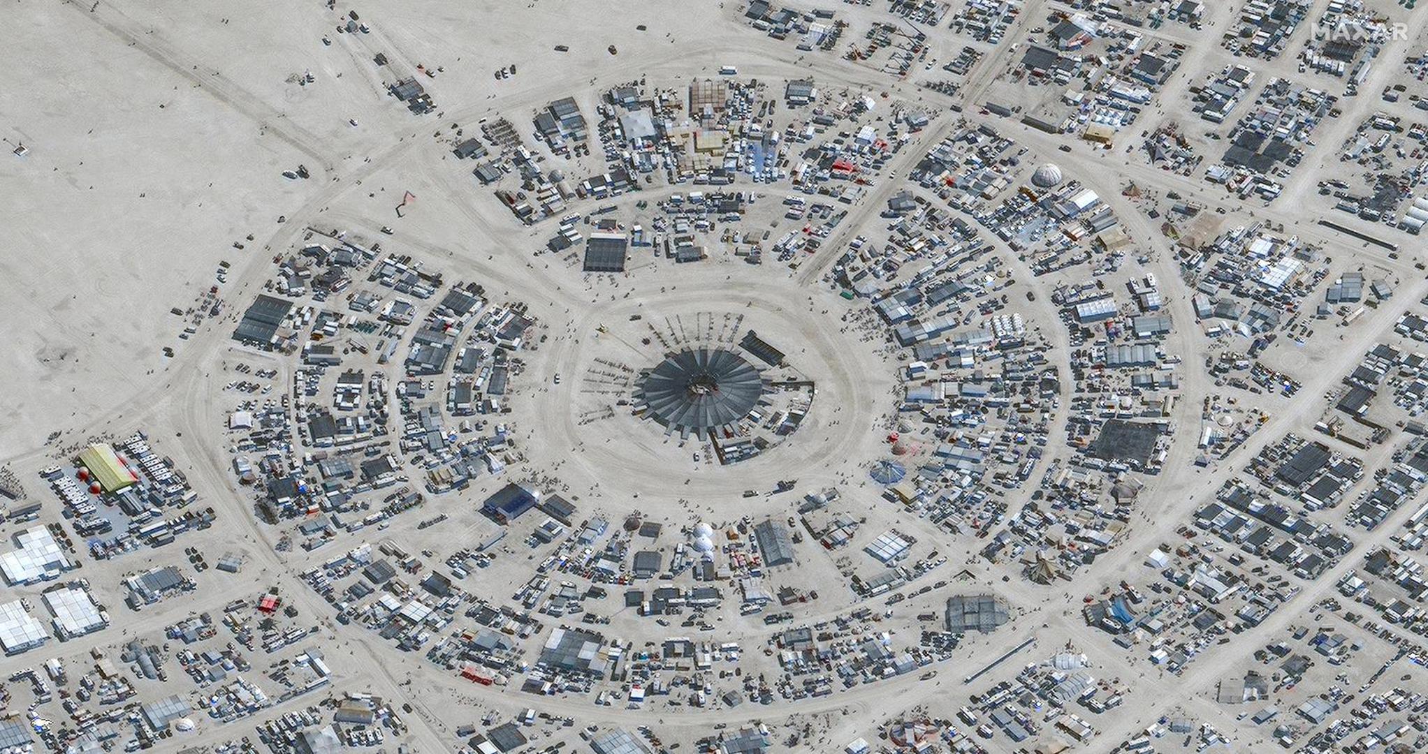 A satellite view shows the center camp during the 2023 Burning Man festival, in Black Rock Desert, Nevada, U.S., August 28, 2023.  Maxar Technologies/Handout via REUTERS THIS IMAGE HAS BEEN SUPPLIED BY A THIRD PARTY. NO RESALES. NO ARCHIVES. MANDATORY CREDIT. DO NOT OBSCURE LOGO. Photo: MAXAR TECHNOLOGIES/REUTERS