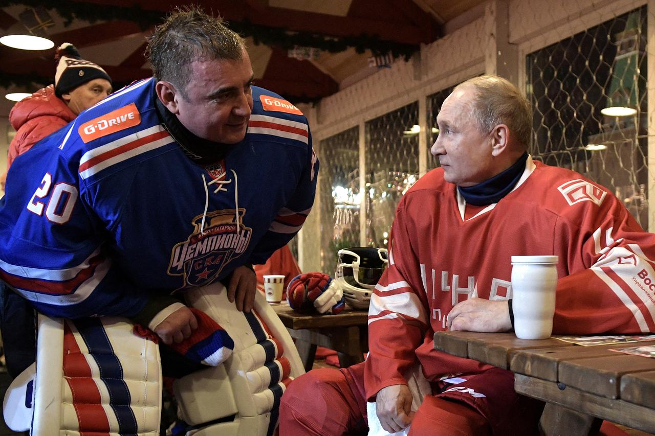 FILE PHOTO: Russian President Vladimir Putin and governor of Tula region Alexei Dyumin take part in a gala match of the Night Hockey league at an ice rink in Red Square in Moscow