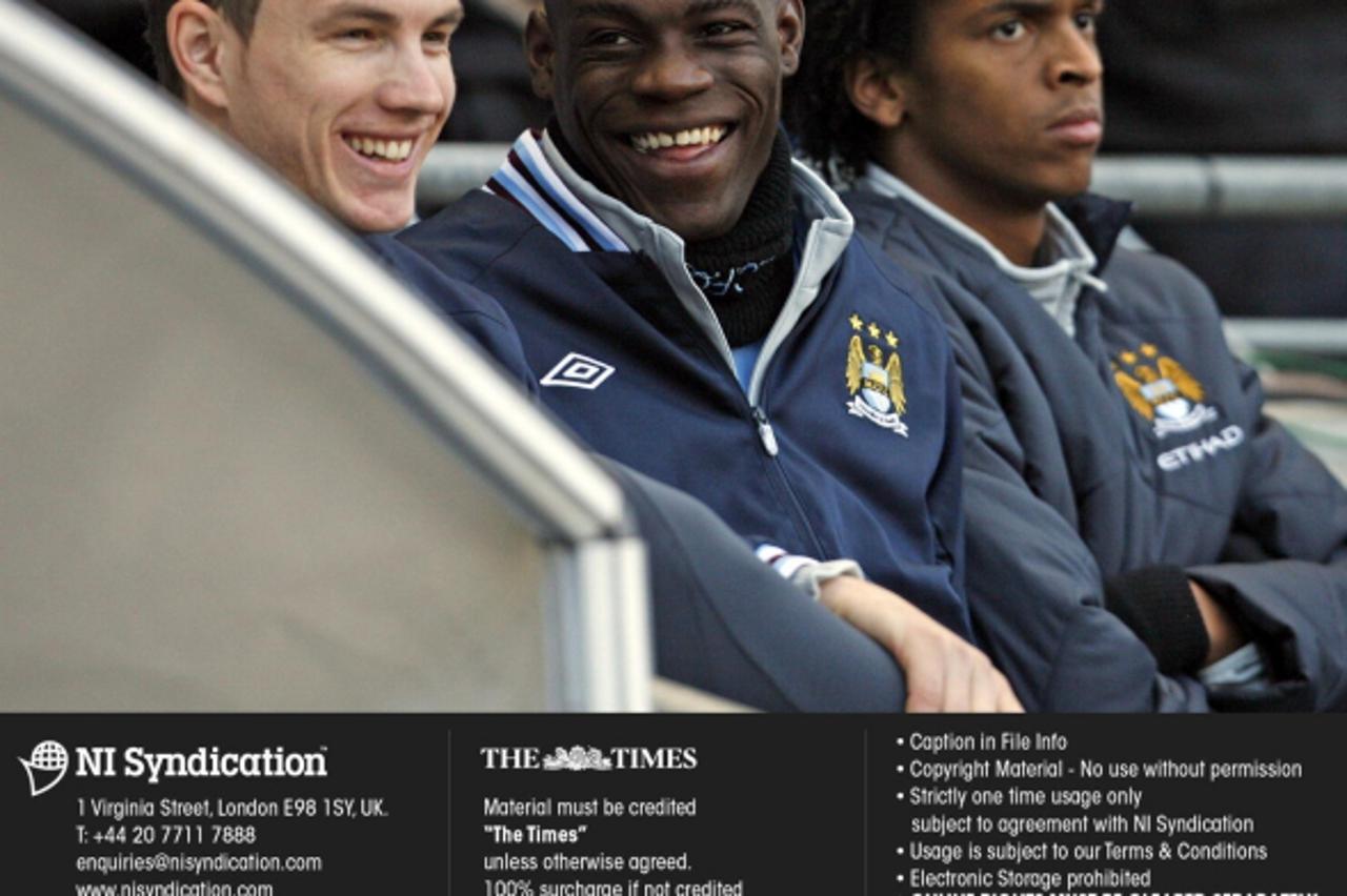 'Manchester City v Reading. FA Cup quarter-final. Mario Balotelli shares a joke with team mate Edin Dzeko Credit: The Times. Online rights must be cleared by N.I.Syndication Photo: NI Syndication/PIXS