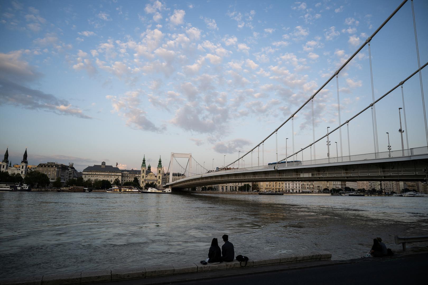 People sit on the edge of a quay next to the Danube River in Budapest, Hungary, September 18, 2024. REUTERS/Marton Monus Photo: MARTON MONUS/REUTERS