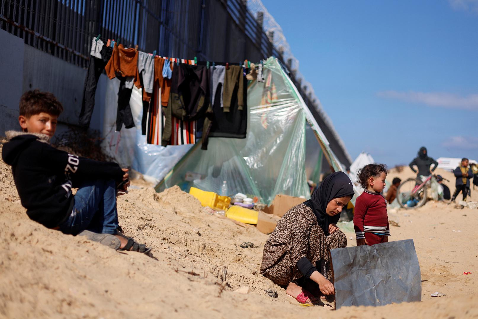 Displaced Palestinian woman Laila Abu Mustafa, who fled her house due to Israeli strikes, shelters at the border with Egypt, in Rafah in the southern Gaza Strip, February 10, 2024. REUTERS/Mohammed Salem Photo: MOHAMMED SALEM/REUTERS