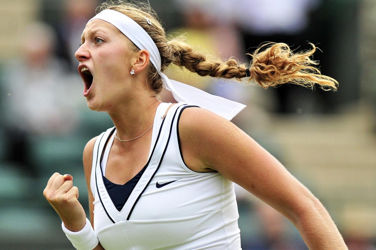 \'Czech player Petra Kvitova reacts after winning a point over Bulgarian player Tsvetana Pironkova during the women\'s guarter final at the Wimbledon Tennis Championships at the All England Tennis Clu