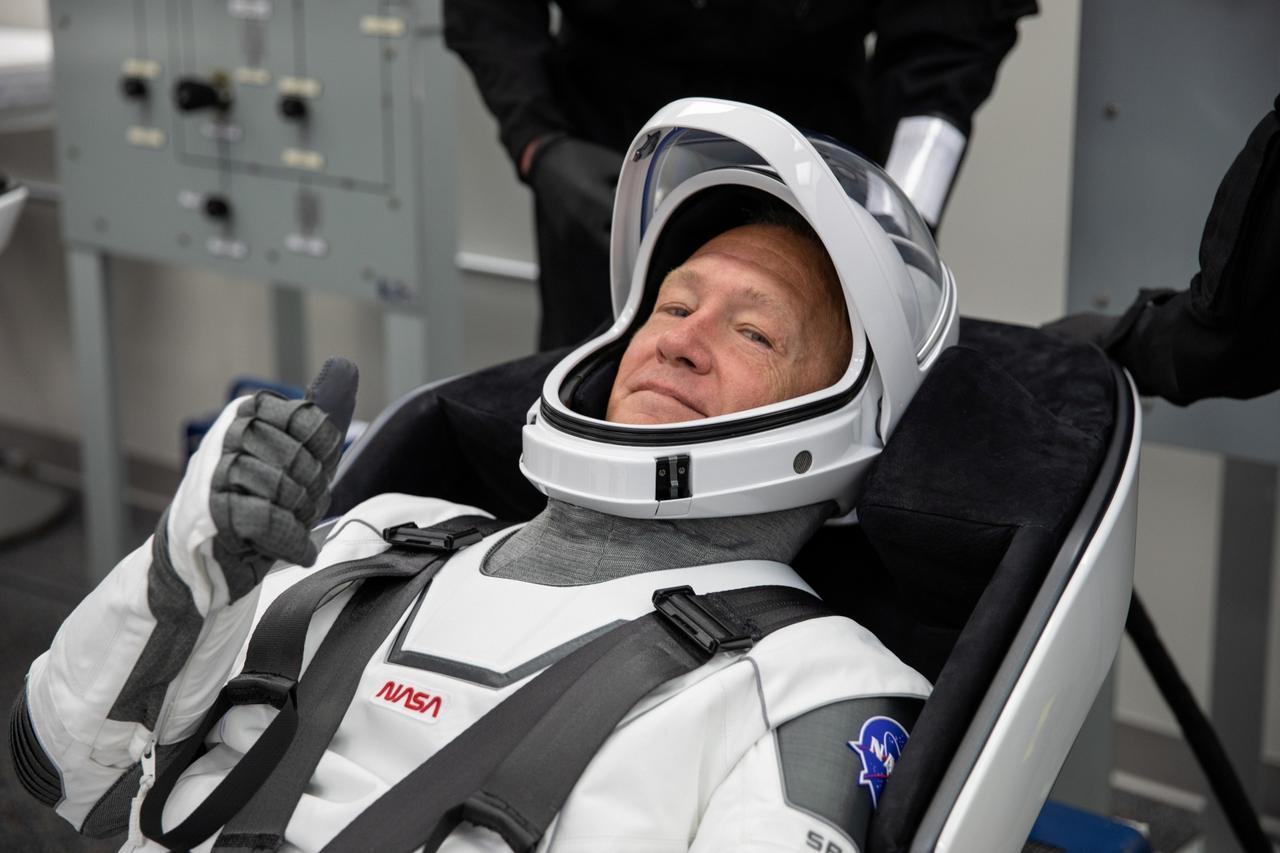 FILE PHOTO: The crew access arm is swung into position to a SpaceX Falcon 9 rocket with the company's Crew Dragon spacecraft onboard