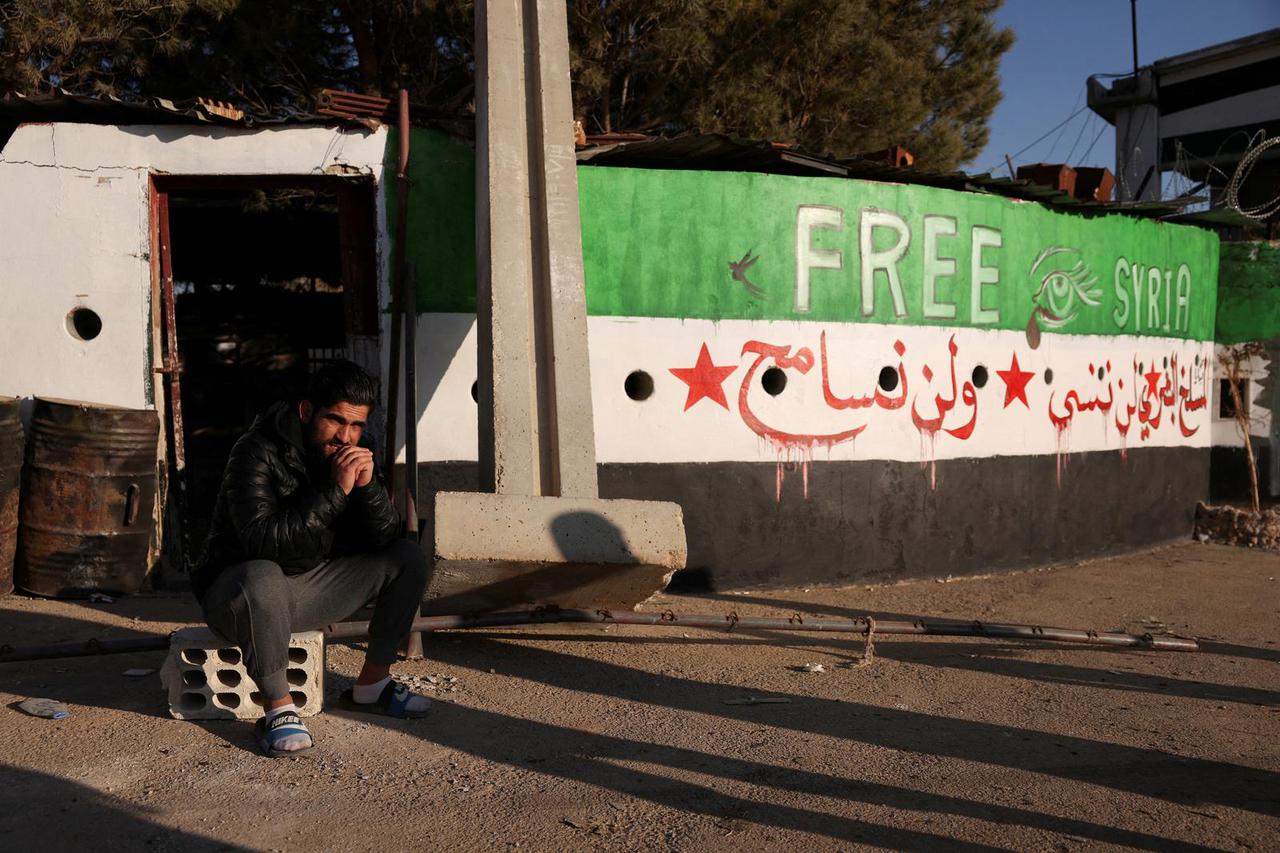 A man sits outside Sednaya prison in Sednaya