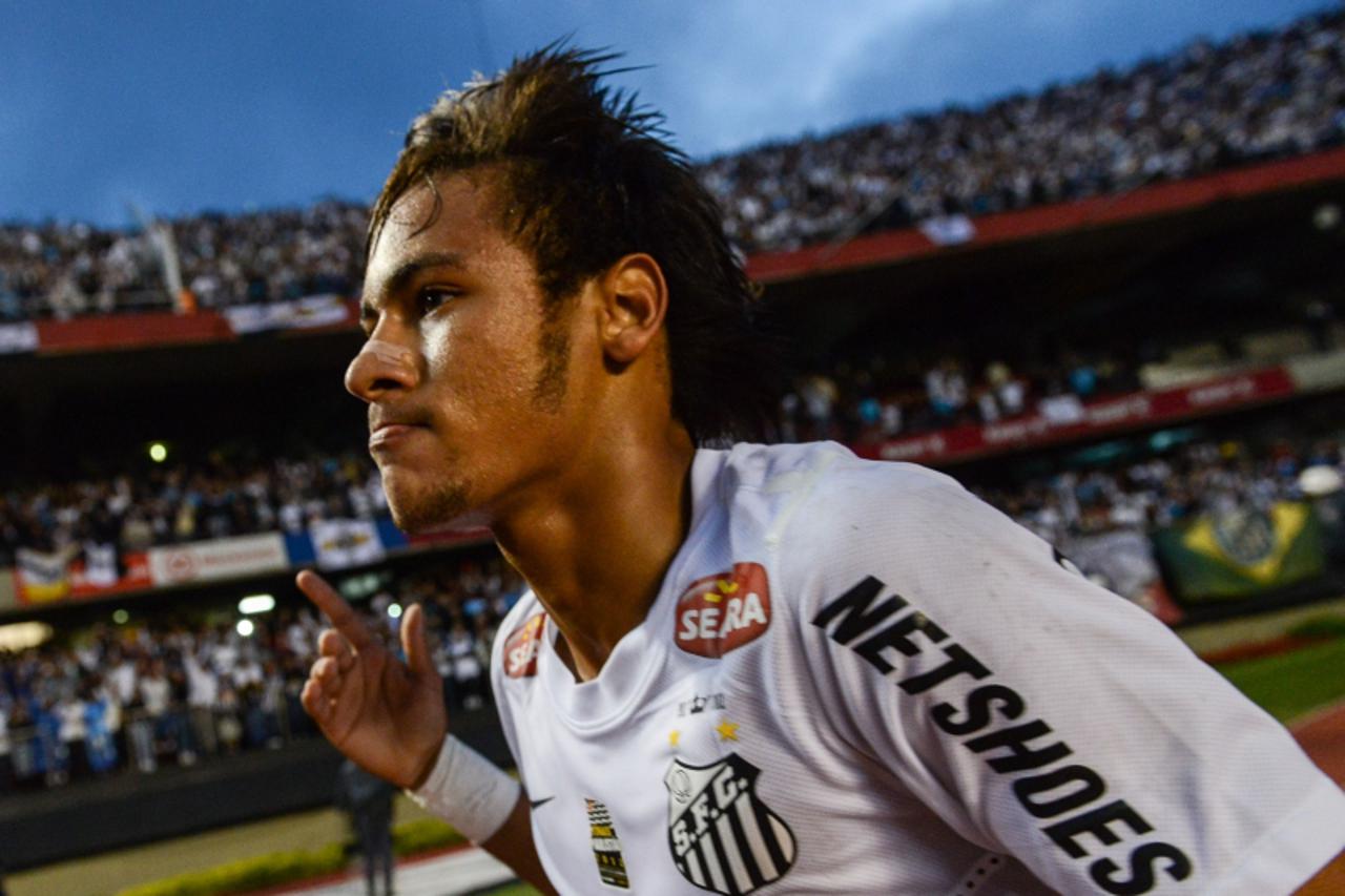 'Santos\'s footballer Neymar celebrates after scoring against Guarani in the final of the Paulista Championship -- the main football tournament of the state of Sao Paulo -- at Morumbi stadium in Sao P