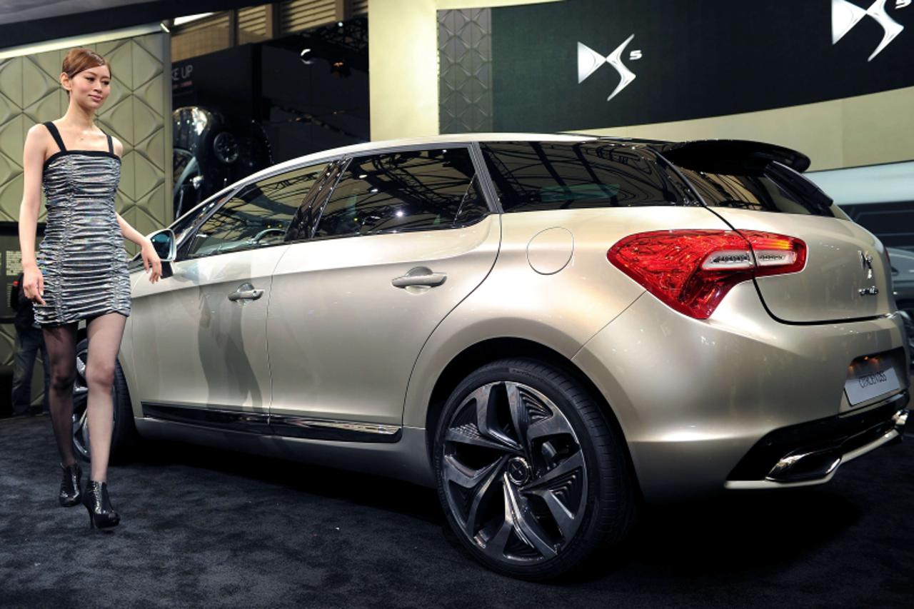 'A model walks by the new Citroen DS5 at the Shanghai Auto Show in Shanghai on April 19, 2011. About 2,000 car and parts makers from 20 countries are participating in the Shanghai auto show, showcasin