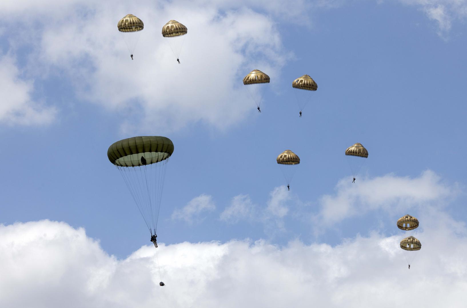 Paratroopers making a commemorative jump into fields around the French village of Sanneville in Normandy as part of the 80th anniversary of D-day. 05.06.2024   Material must be credited "The Times/News Licensing" unless otherwise agreed. 100% surcharge if not credited. Online rights need to be cleared separately. Strictly one time use only subject to agreement with News Licensing Photo: Richard Pohle/NEWS SYNDICATION