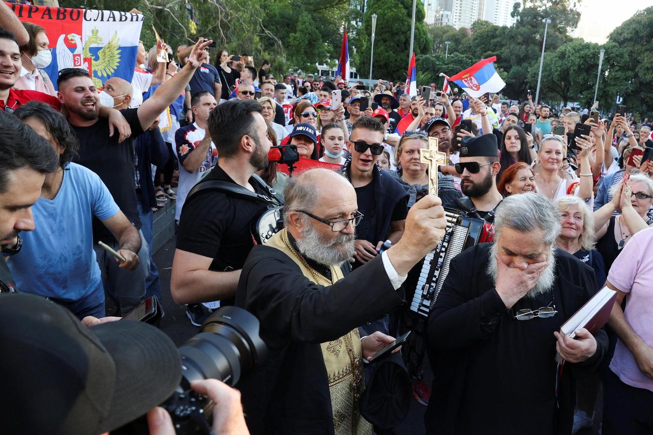 Supporters gather outside the hotel where Novak Djokovic is believed to be held in Melbourne