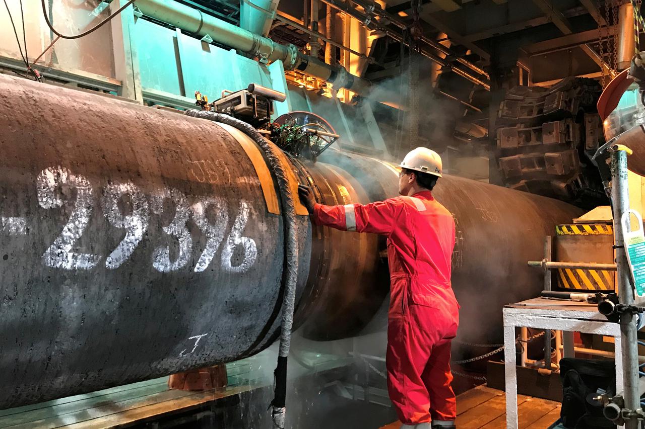 FILE PHOTO: A specialist works onboard the Allseas' deep sea pipe laying ship Solitaire to prepare a pipe for Nord Stream 2 pipeline in the Baltic Sea