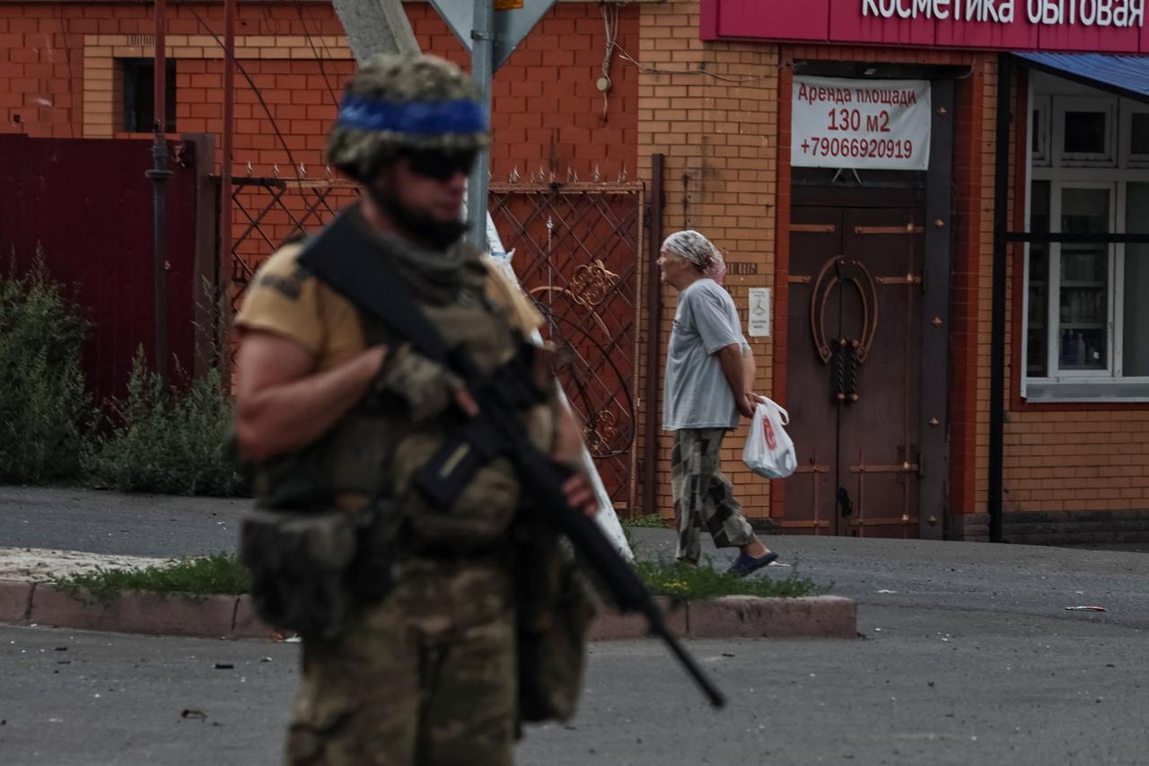 A Ukrainian serviceman patrols in the town of Sudzha