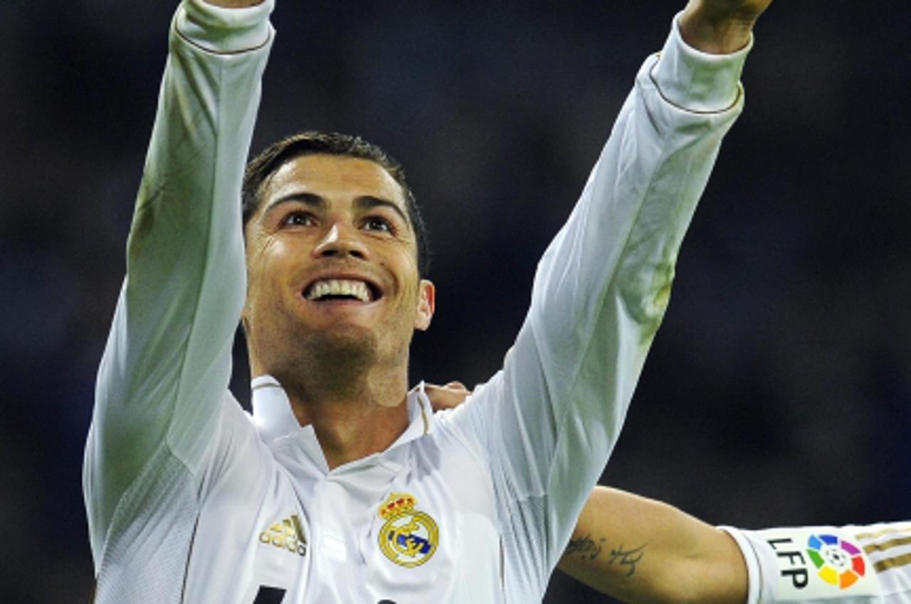 'Real Madrid\'s Cristiano Ronaldo celebrates after scoring against Atletico Madrid during their Spanish first division soccer match at Santiago Bernabeu stadium in Madrid November 26, 2011.  REUTERS/F