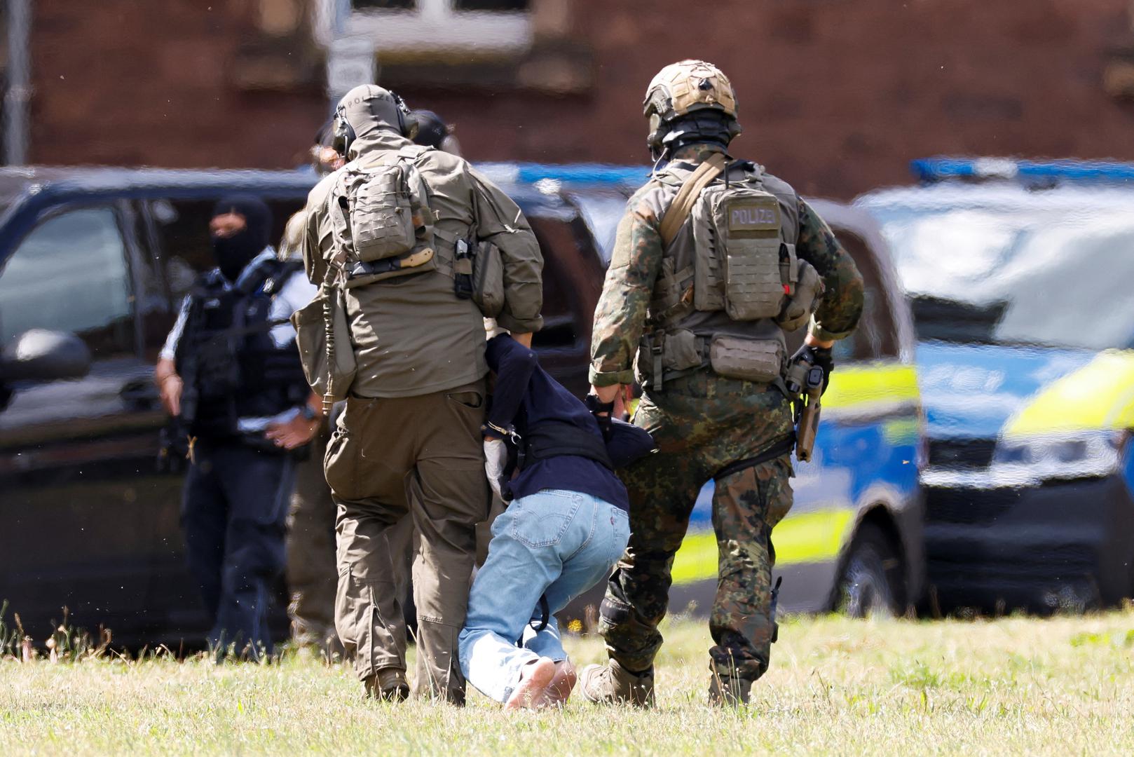 A 26-year-old Syrian man, who is the suspect in custody for a stabbing rampage in the western German city of Solingen in which several individuals were killed, is escorted by police on his way to the Federal Public Prosecutor in Karlsruhe, Germany, August 25, 2024. REUTERS/Heiko Becker Photo: Heiko Becker/REUTERS