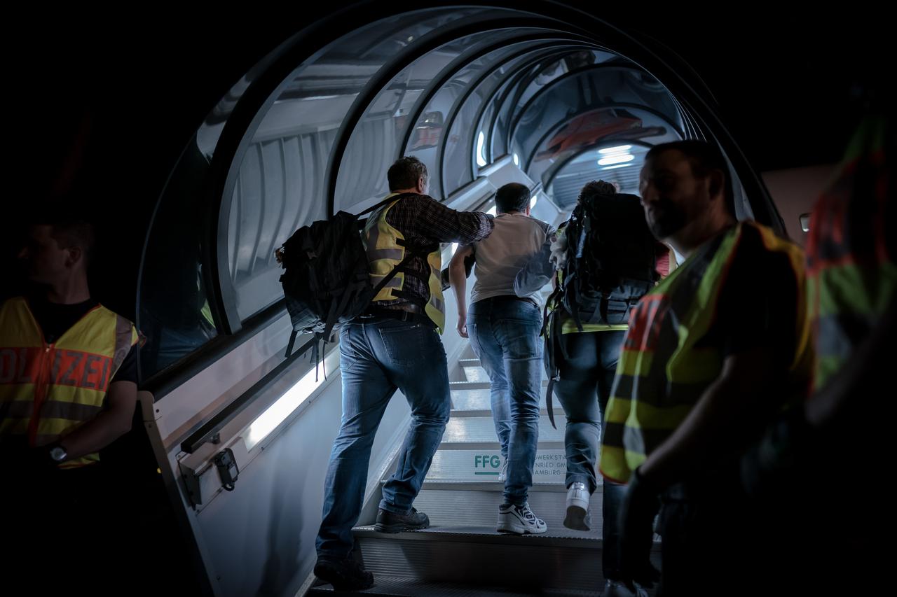 olice officers accompany an Afghan at Leipzig-Halle Airport on a charter aircraft. 45 rejected asylum seekers were deported on a special flight to Afghanistan's capital Kabul