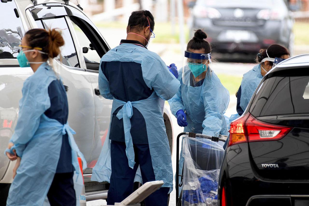 Healthcare workers administer COVID-19 tests at St Vincent's Hospital drive-through testing clinic at Bondi Beach in Sydney