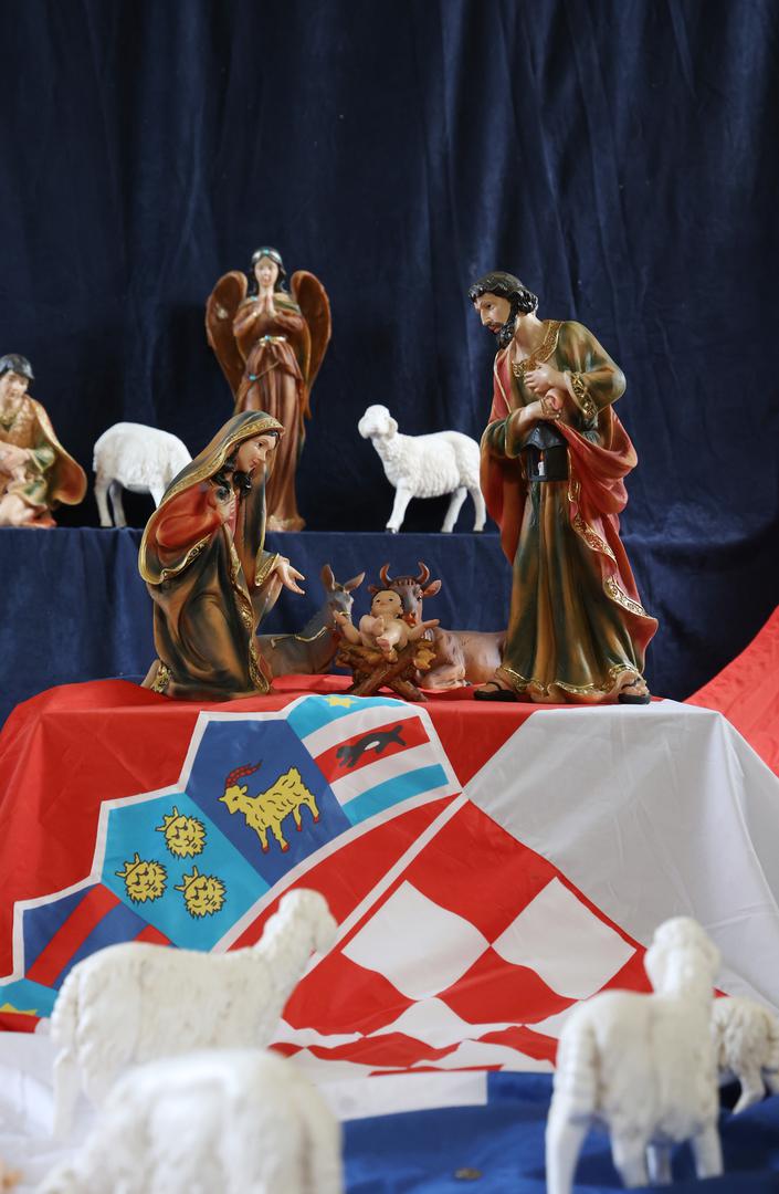 S druge strane, desna strana prikazuje tradicionalni prizor Svete obitelji – Isusa, Josipa i Marije – uz hrvatsku zastavu i nekoliko ovčica. U sredini jaslica nalazi se natpis "Ti biraš", koji dodatno naglašava simboliku prikaza.