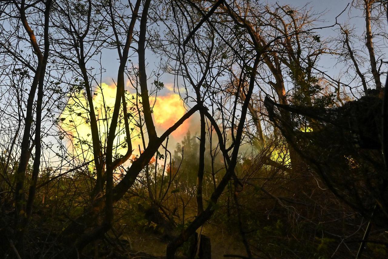 Ukrainian servicemen fire an AS-90 self-propelled howitzer towards Russian troops at a front line in Kharkiv region