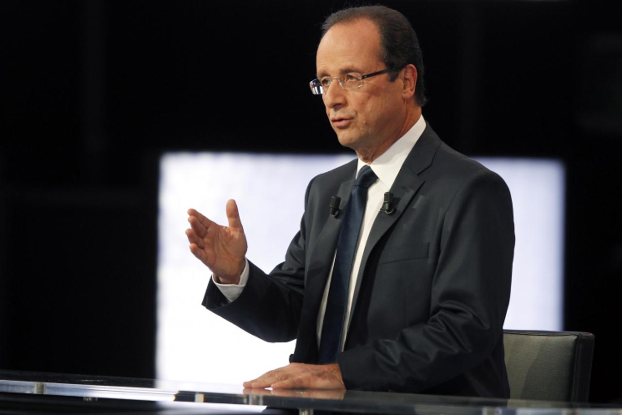 'epa03179118 French socialist party (PS) candidate for the 2012 French presidential election, Francois Hollande,  speaks during a live debate broadcast on French national television channel France2, i