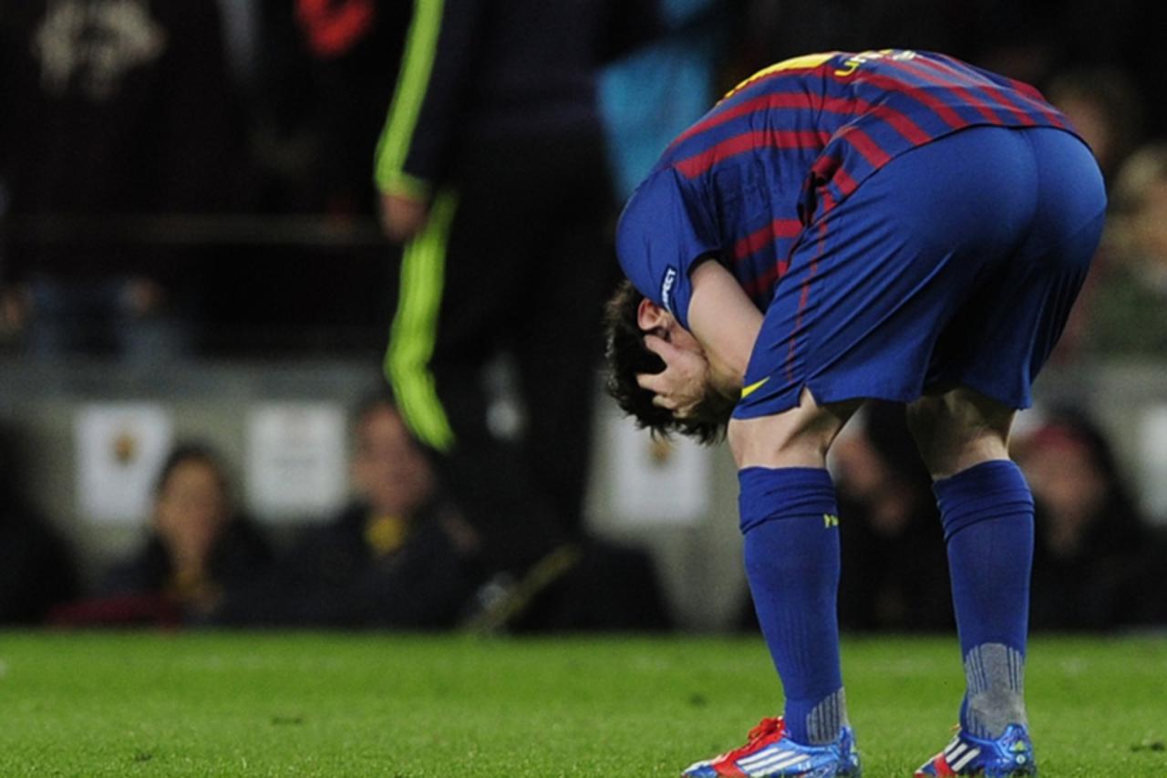 'Barcelona\'s Argentinian forward Lionel Messi kneels down as Barcelona lose to Chelsea during the UEFA Champions League second leg semi-final football match Barcelona against Chelsea at the Cam Nou s