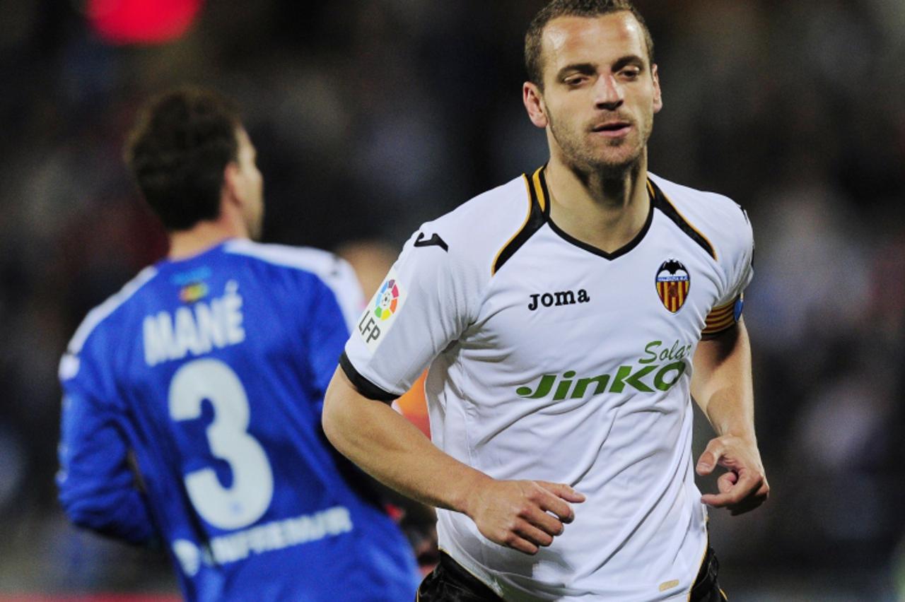 'Valencia's forward Roberto Soldado celebrates after scoring his team's first goal during the Spanish league football match between Getafe and Valencia at Alfonso Perez stadium in Getafe near Madrid