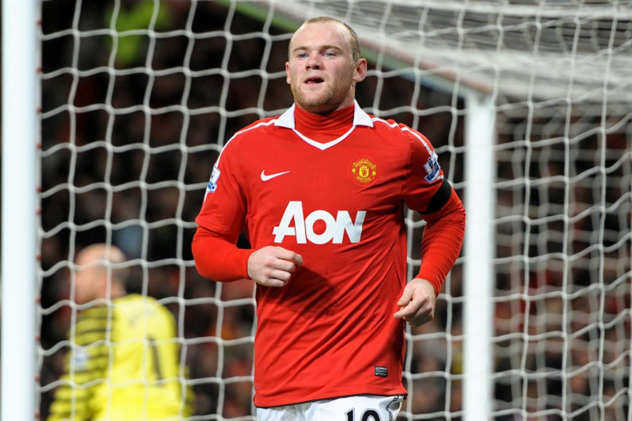 'Manchester United\'s English striker Wayne Rooney celebrates scoring his second goal during the English Premier League football match between Manchester United and Aston Villa at Old Trafford in Manc