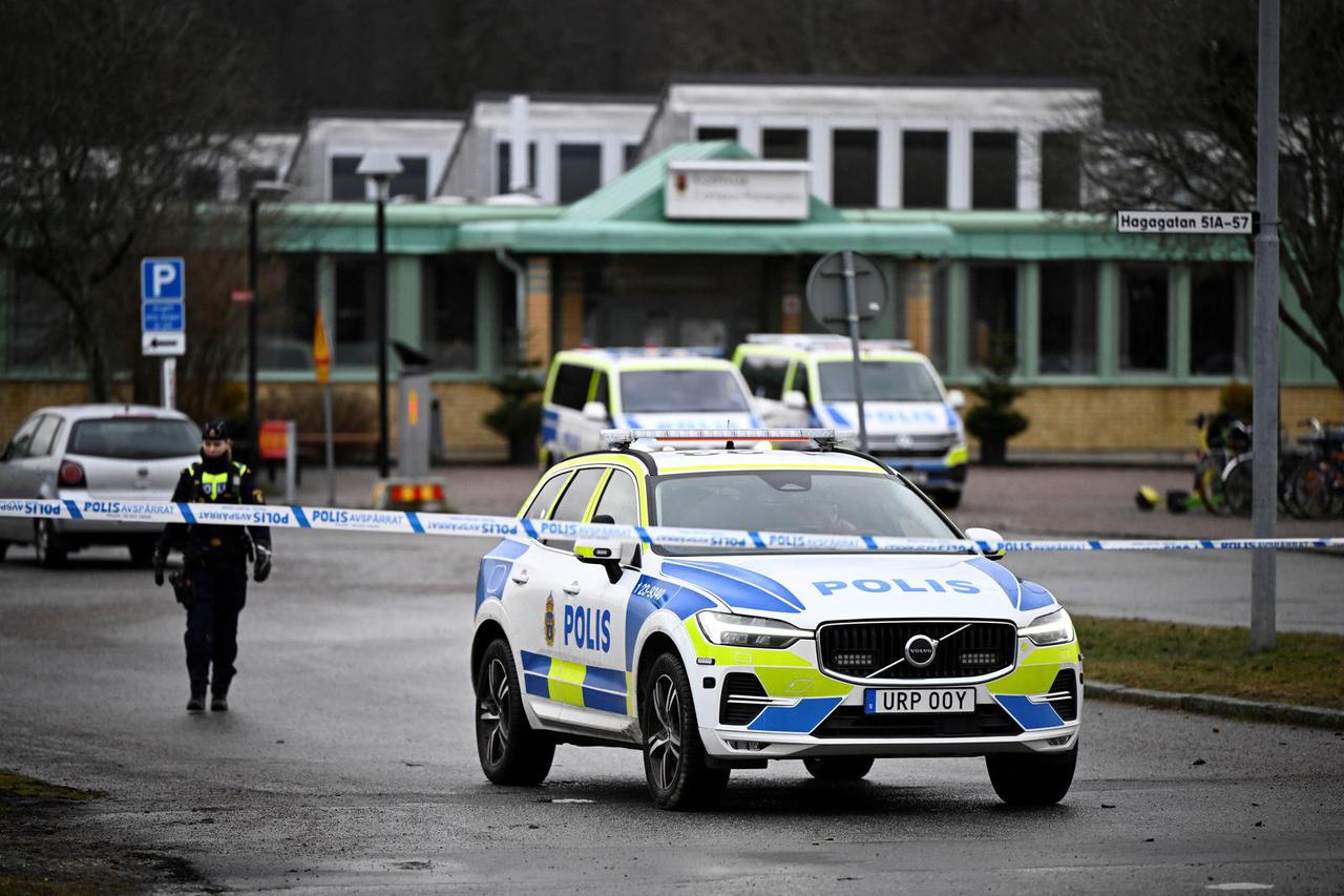 A police car is parked area around Risbergska Campus the day after the school shooting at Risbergska School in Orebro