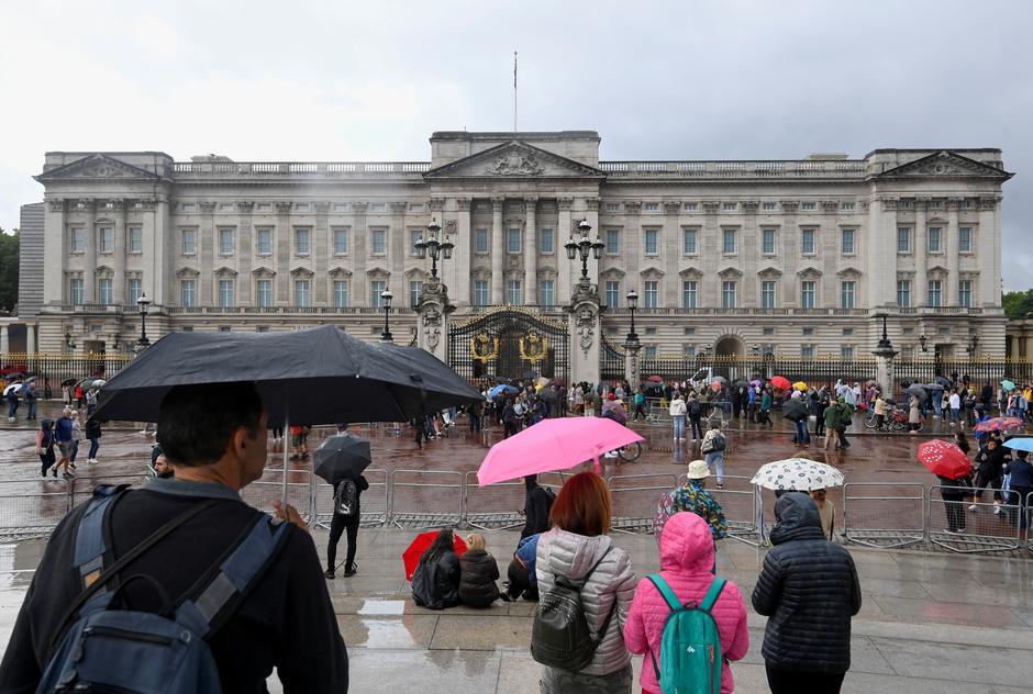 People gather outside Buckingham Palace in London