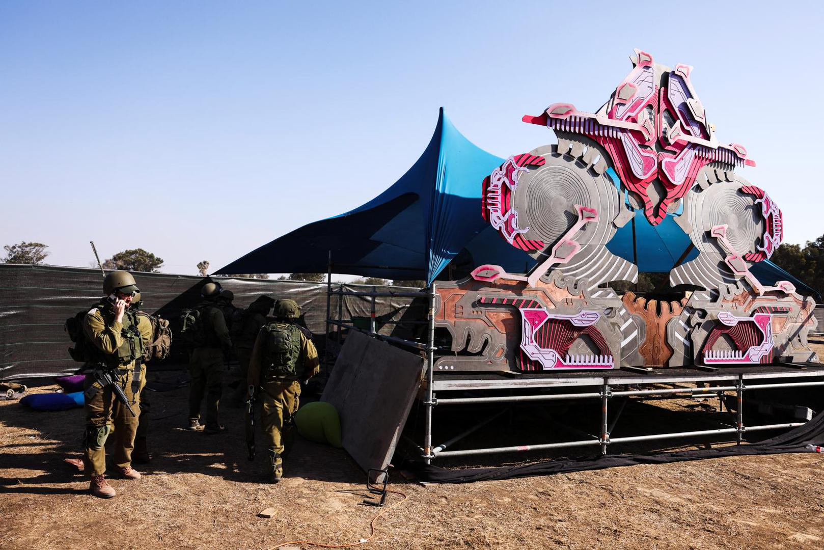 Israeli soldiers gather at the site of an attack on the Nova Festival by Hamas gunmen from Gaza, near Israel's border with the Gaza Strip, in southern Israel, October 12, 2023. REUTERS/Ronen Zvulun Photo: RONEN ZVULUN/REUTERS