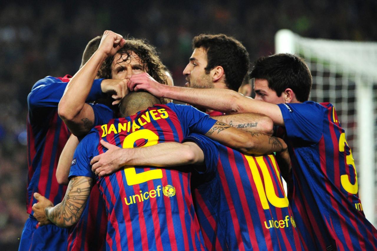 'Barcelona\'s Argentinian forward Lionel Messi celebrates with teammates scoring  a penalty during the Champions League quarter-final second leg football match FC Barcelona vs AC Milan on April 3, 201