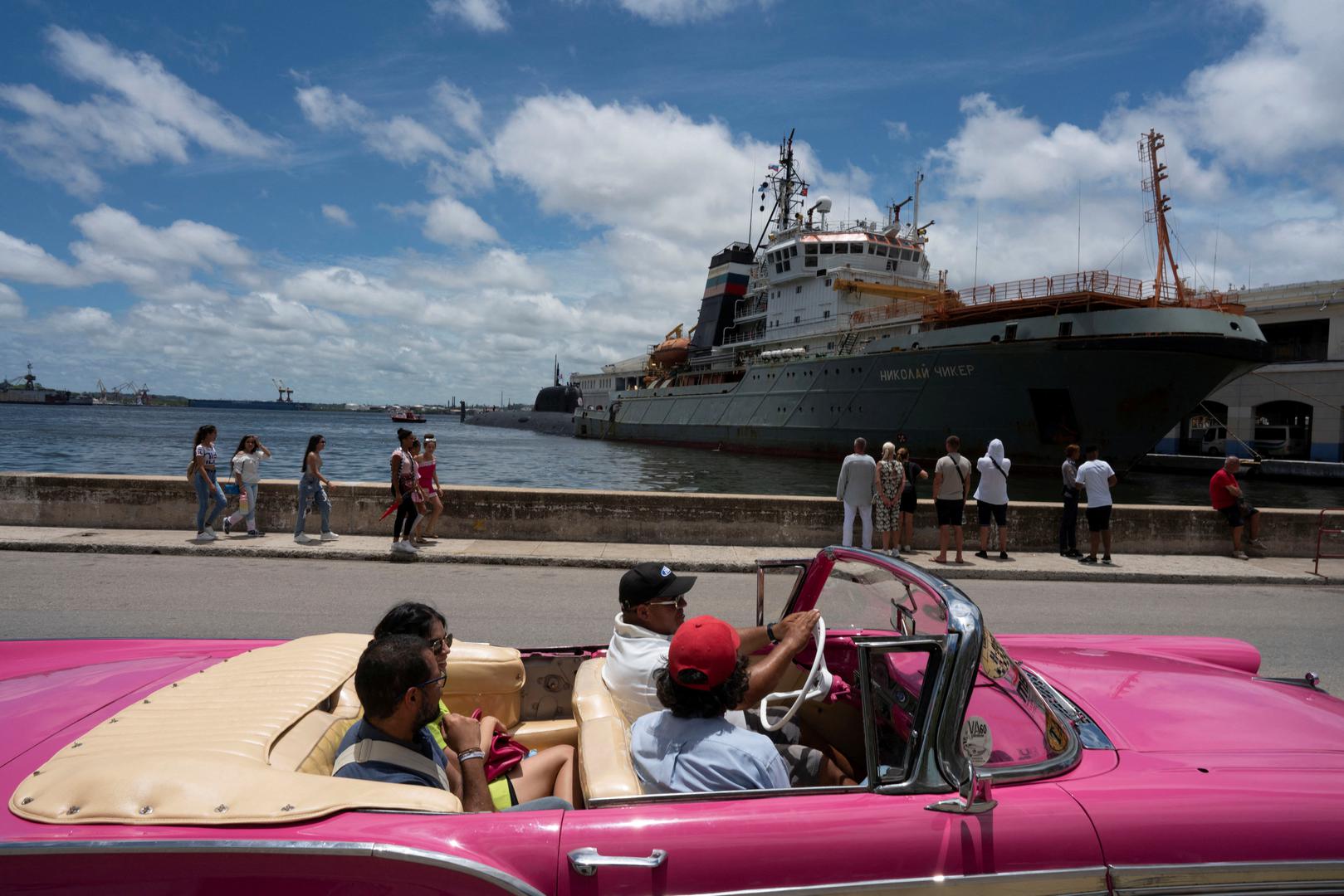 Tourists pass by Russian a nuclear-powered cruise missile submarine Kazan and tug boat Nikolay Chiker, docked in Havana's bay, Cuba, June 13, 2024. REUTERS/Alexandre Meneghini Photo: ALEXANDRE MENEGHINI/REUTERS