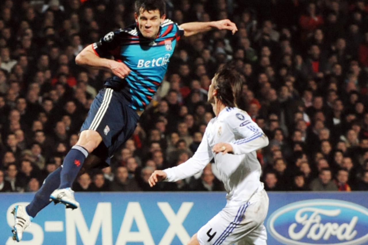 'Lyon\'s Croatian defender Dejan Lovren (L) vies with Real Madrid\'s Spanish defender Sergio Ramos during the Champions League football match Olympique de Lyon versus Real Madrid on February 22, 2011 