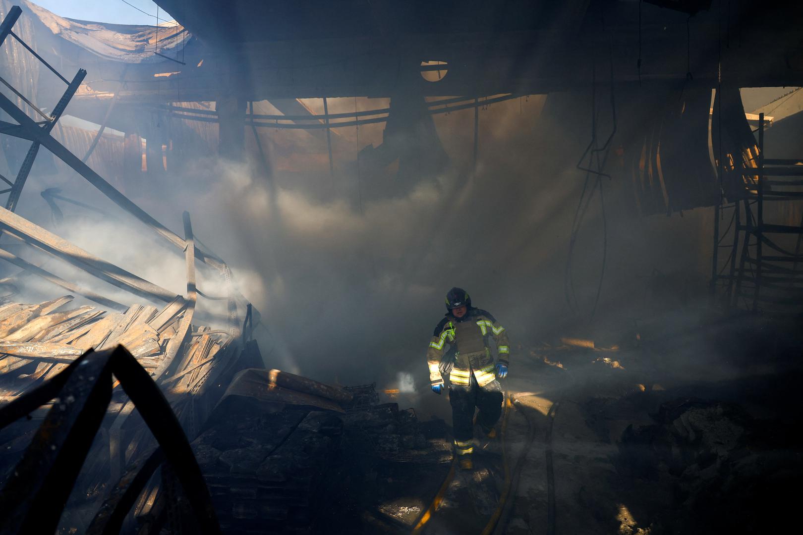 A firefighter works at the site of a household item shopping mall which was hit by a Russian air strike, amid Russia's attack on Ukraine, in Kharkiv, Ukraine, May 25, 2024. REUTERS/Valentyn Ogirenko Photo: VALENTYN OGIRENKO/REUTERS