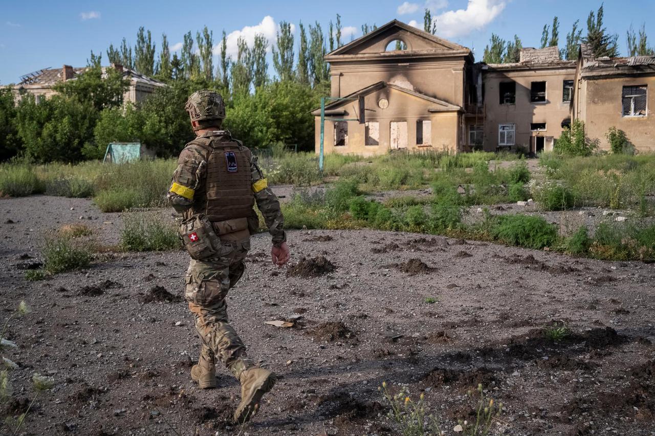 A Ukrainian serviceman walks down a street in the frontline town of Chasiv Yar