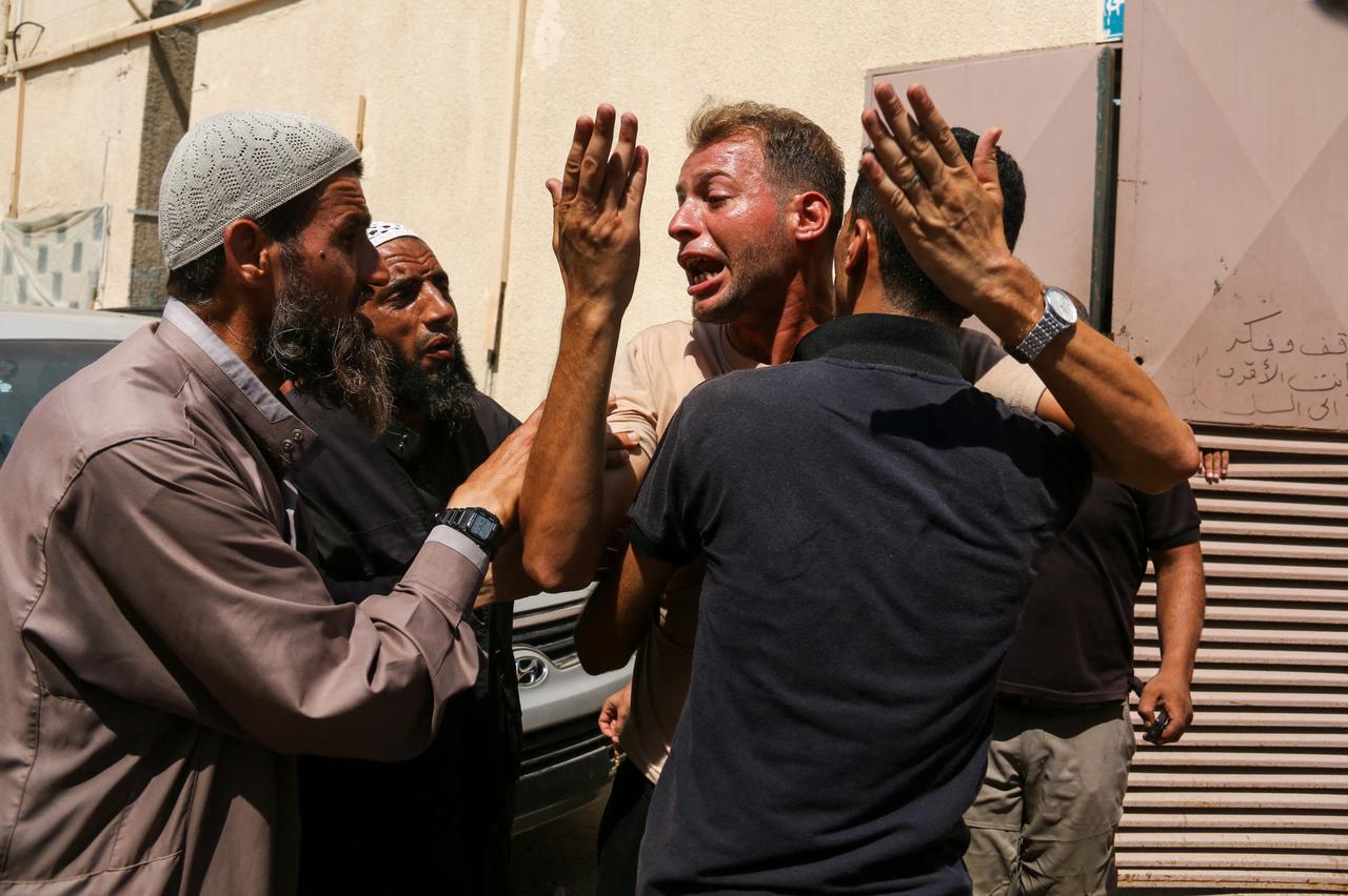 A Palestinian Mourns During Funeral of His Children - Deir al-Balah