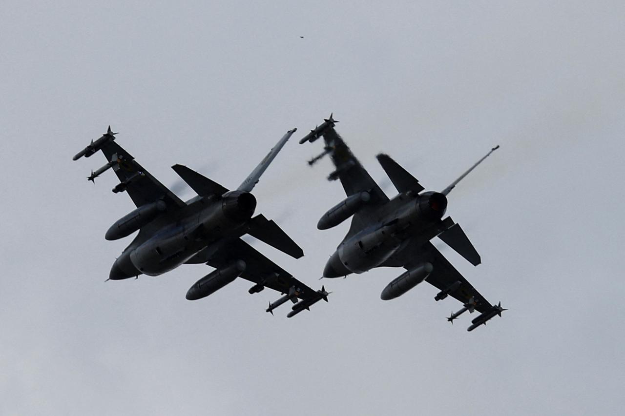 Ukrainian F-16 fighting aircrafts are seen in the air during marking the Day of the Ukrainian Air Forces in an undisclosed location in Ukraine