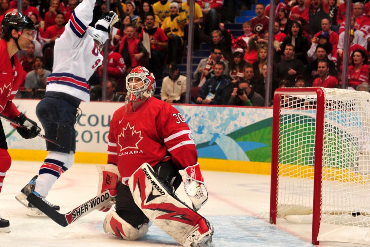 'Canada\'s goalkeeper Martin Brodeur (R) misses a shot by USA\'s defender Brian Rafalski (not on picture) during the Men\'s preliminary Ice Hockey match Canada against USA at the XXI Winter Olympic ga