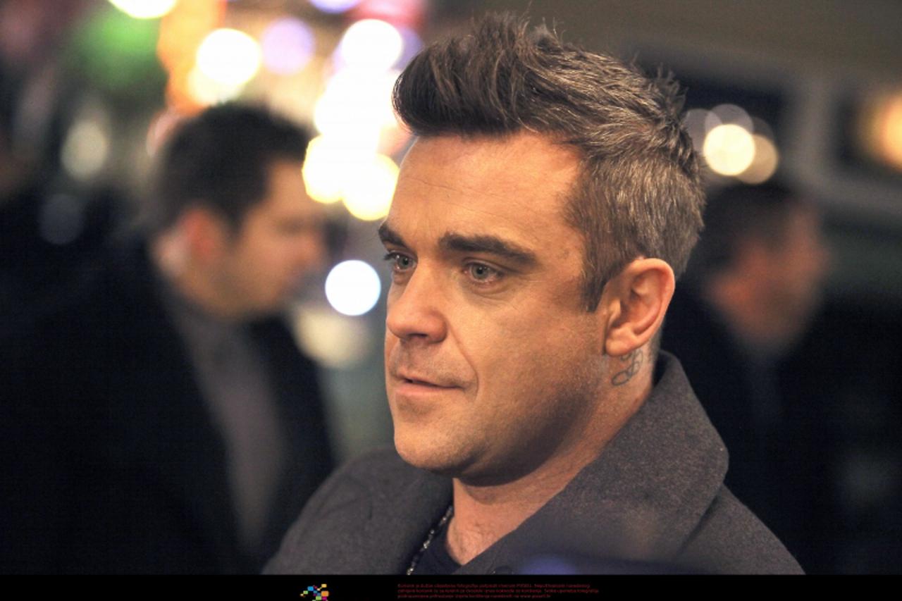 'British singer Robbie Williams visits radio station Antenne and signs autographs in Bad Kreuznach, Germany, 30 November 2012. Antenne Bad Kreuznach won the visit by Williams in a 'Robbie Williams Ra