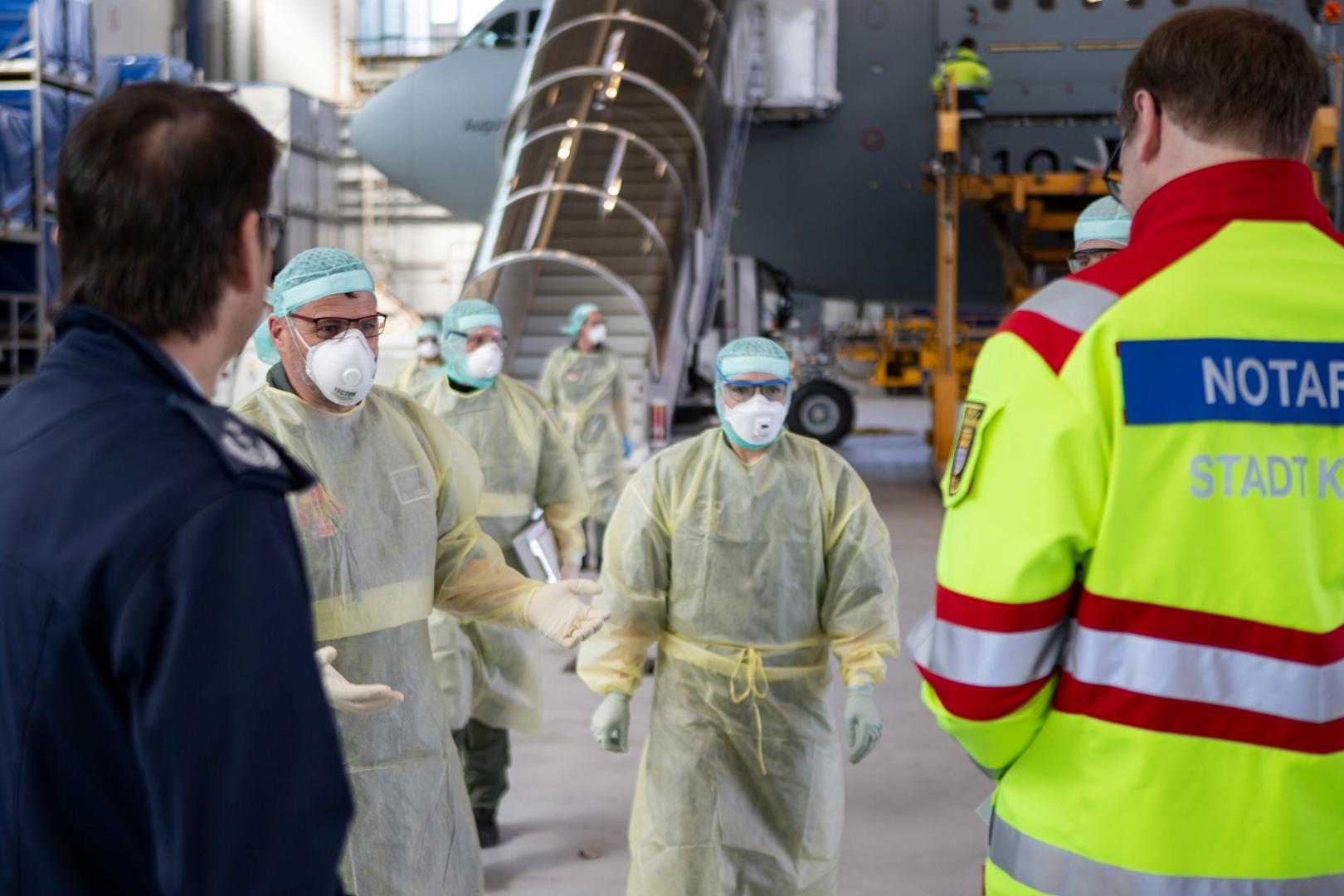 German air force Airbus A-310 "Medivac\ A Bundeswehr handout photo shows staff in protective suits leaving the German air force Airbus A-310 "Medivac" with coronavirus patients from Bergamo, after their arrival in Cologne, Germany, March 28, 2020, as the spread of the coronavirus disease (COVID-19) continues.     Luftwaffe/Kevin Schrief/Handout via Reuters ATTENTION EDITORS - THIS IMAGE HAS BEEN SUPPLIED BY A THIRD PARTY. NO RESALES. NO ARCHIVES. Luftwaffe/Kevin Schrief