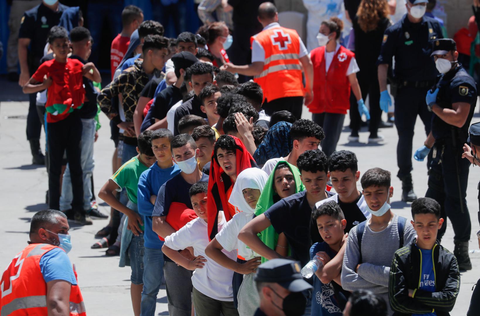 Thousands of migrants cross the Spanish-Moroccan border Moroccan minors queue at a facility prepared for them to rest and have food, after thousands of migrants swam across the Spanish-Moroccan border, in Ceuta, Spain, May 19, 2021. REUTERS/Jon Nazca JON NAZCA