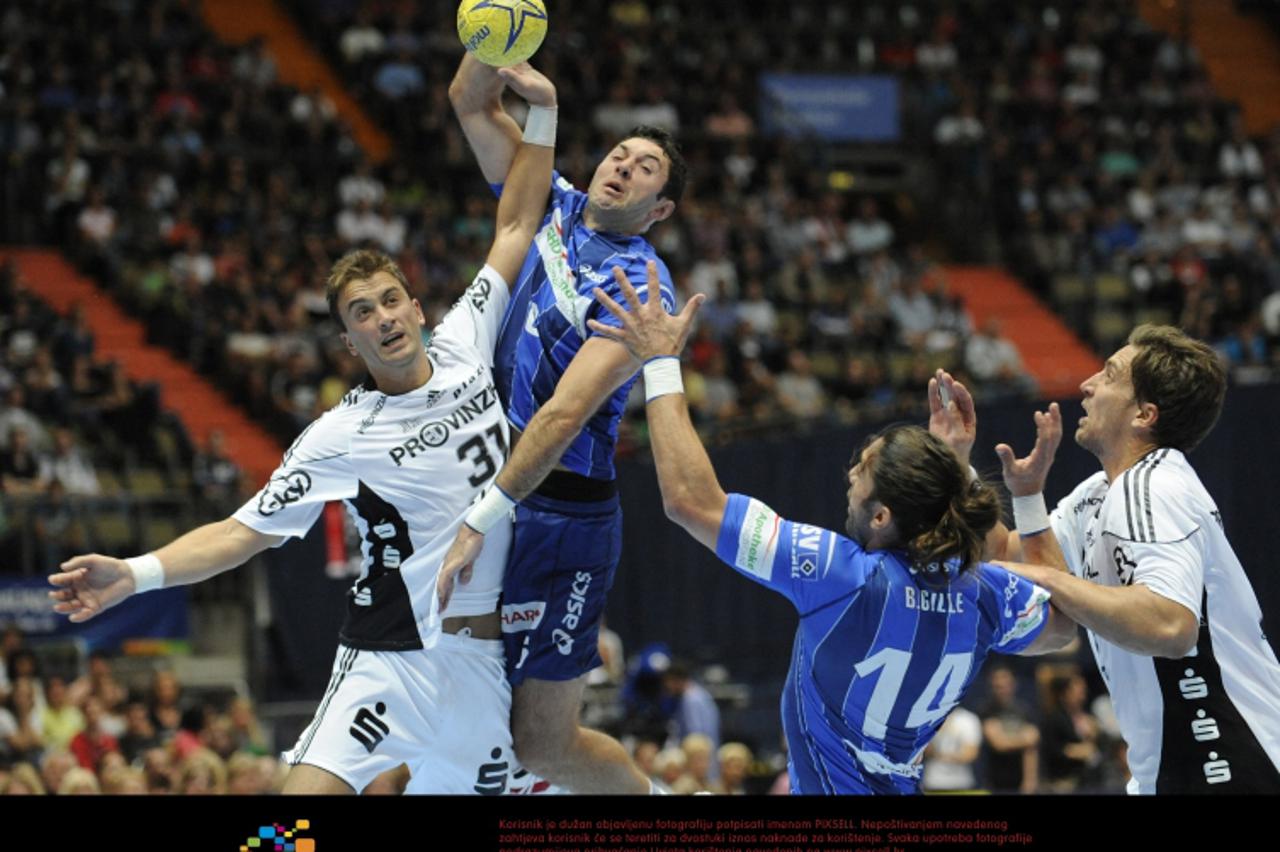 'Kiel\'s Momir Ilic (L) and Hamburg\'s Blazenko Lackovic (2nd to L) vie for the ball during the Handball DHB Supercup match HSV Hamburg vs. THW Kiel at Olympiahalle in Munich, Germany, 30 August 2011.